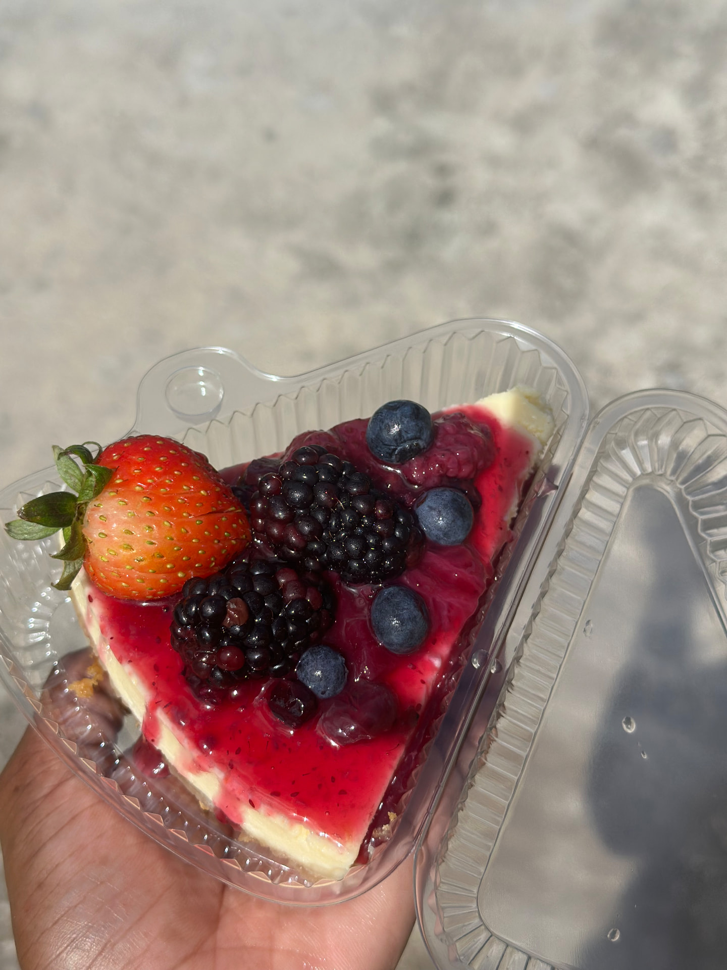 Cheesecake slice topped with mixed berries